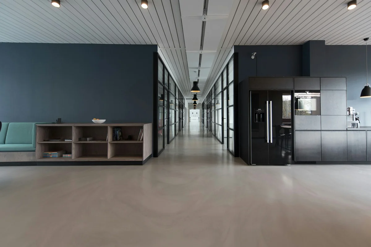 Modern collaborative workspace with warm natural lighting where a local business owner meets their web agency to discuss online visibility